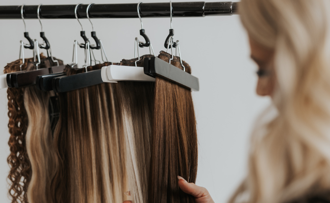 Close-up of weft hair extensions in warm blonde and brunette tones