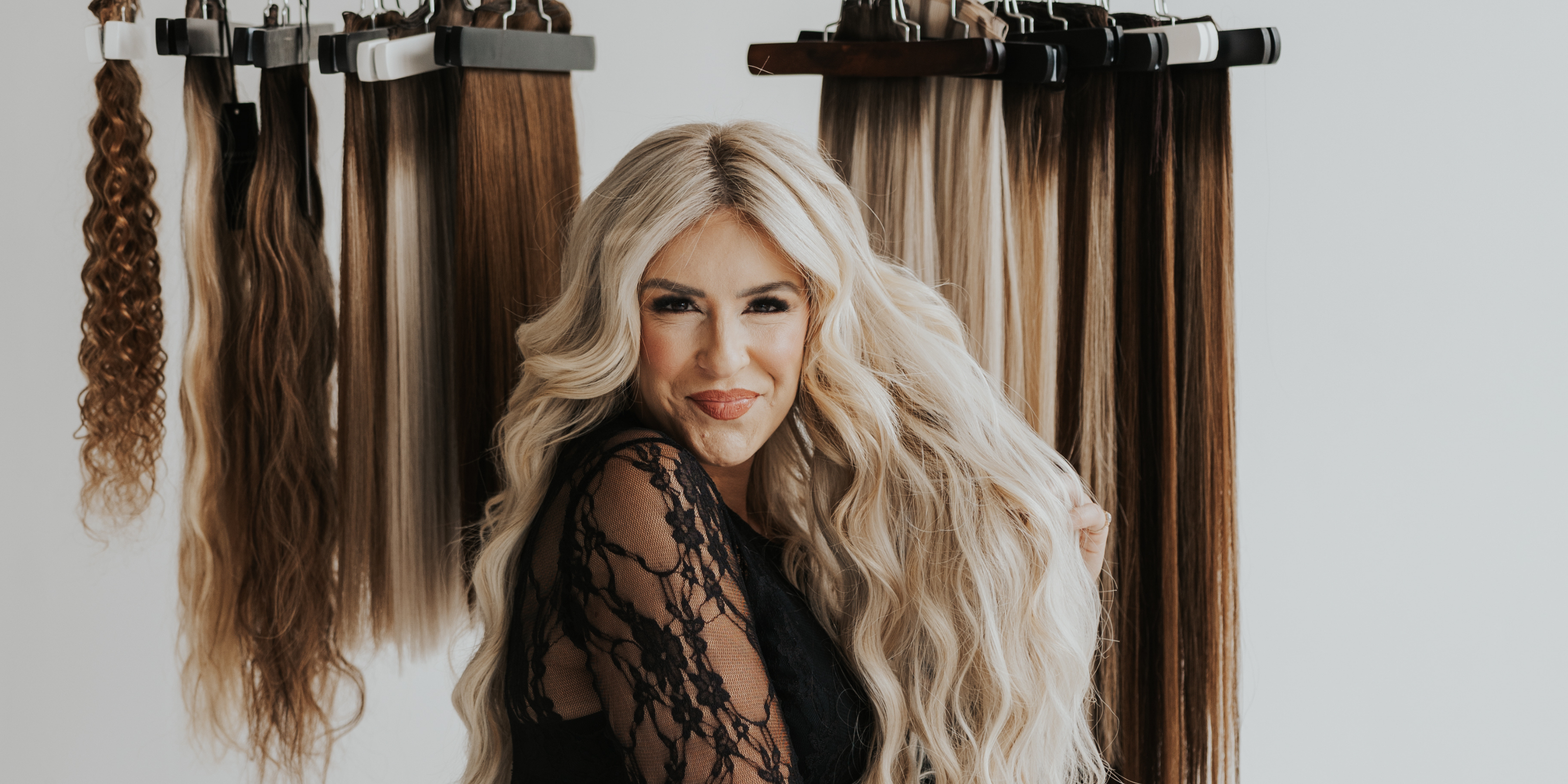 Jessie, founder of Stitched Hair, smiling while wearing Seam Wefts™