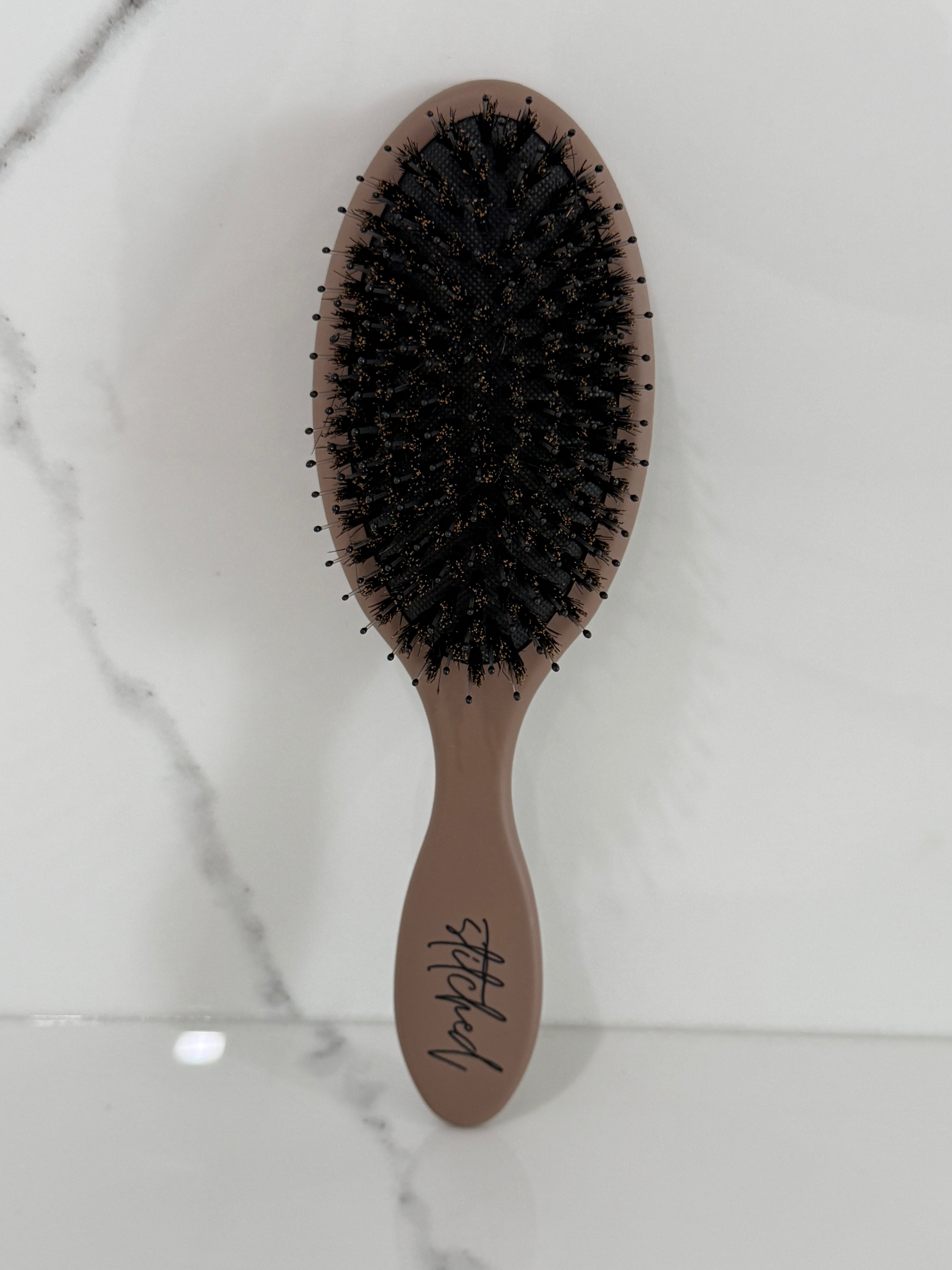 Stitched™ Signature Extension Brush protecting natural hair and Seam Wefts™ during detangling