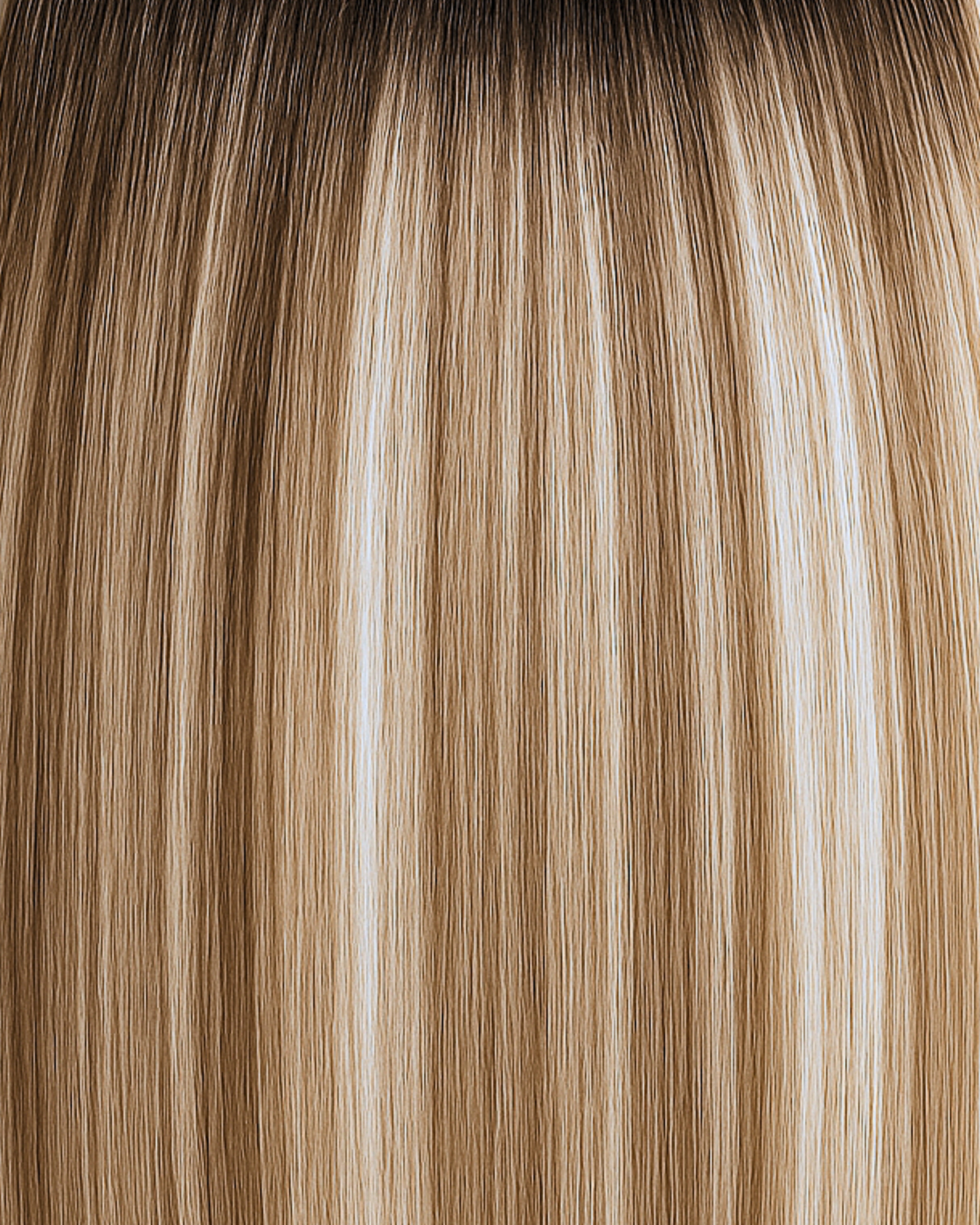 Stitched Hair Inspire Genius Weft™ extensions in rooted neutral bronde with level 9 ash and level 6 neutral tones, featuring a soft level 7 root.