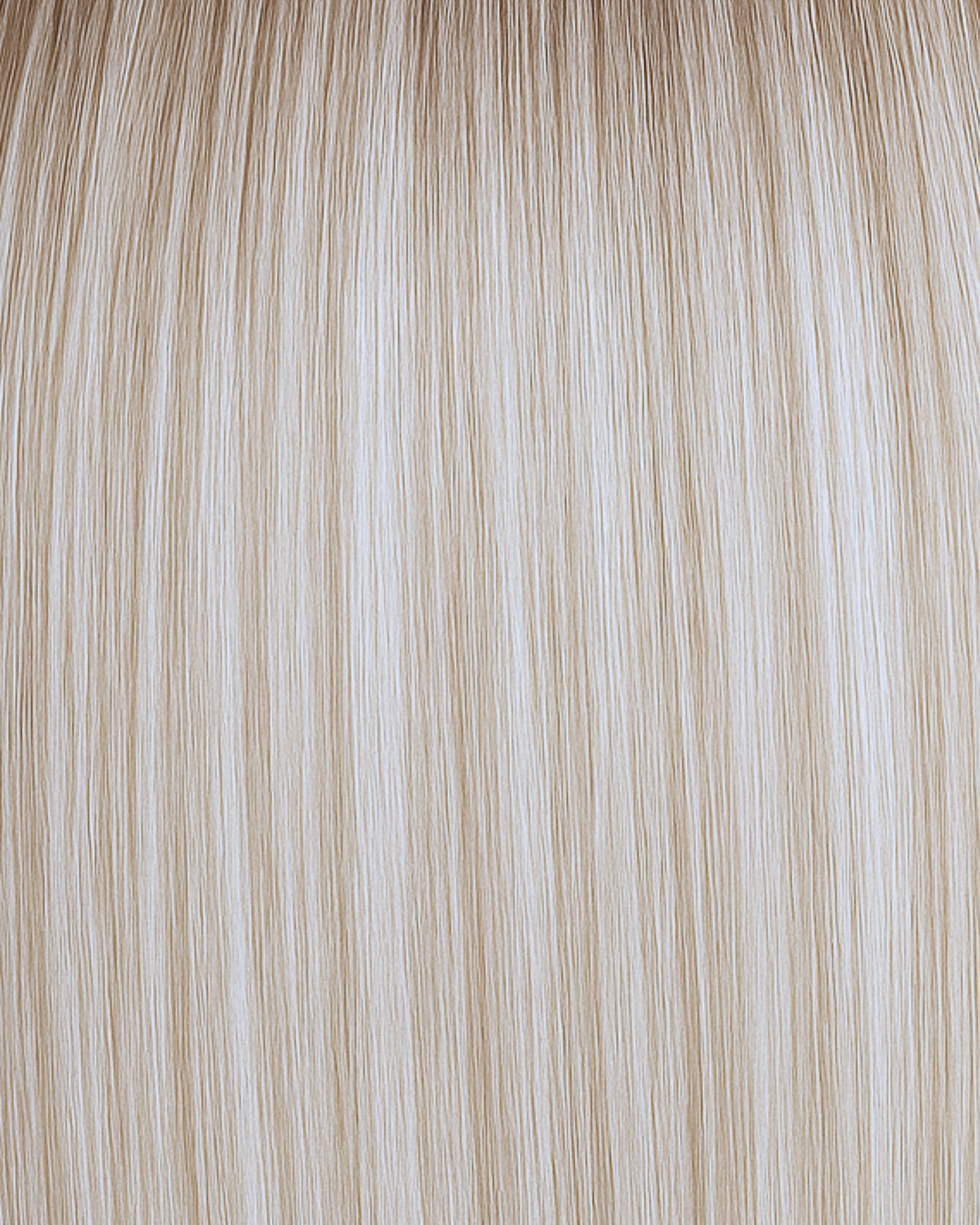 Stitched Hair Radiate Genius Weft™ extensions in rooted platinum blonde with 9 and 10 neutral tones and level 8 root, shown in bright cool-toned strands.