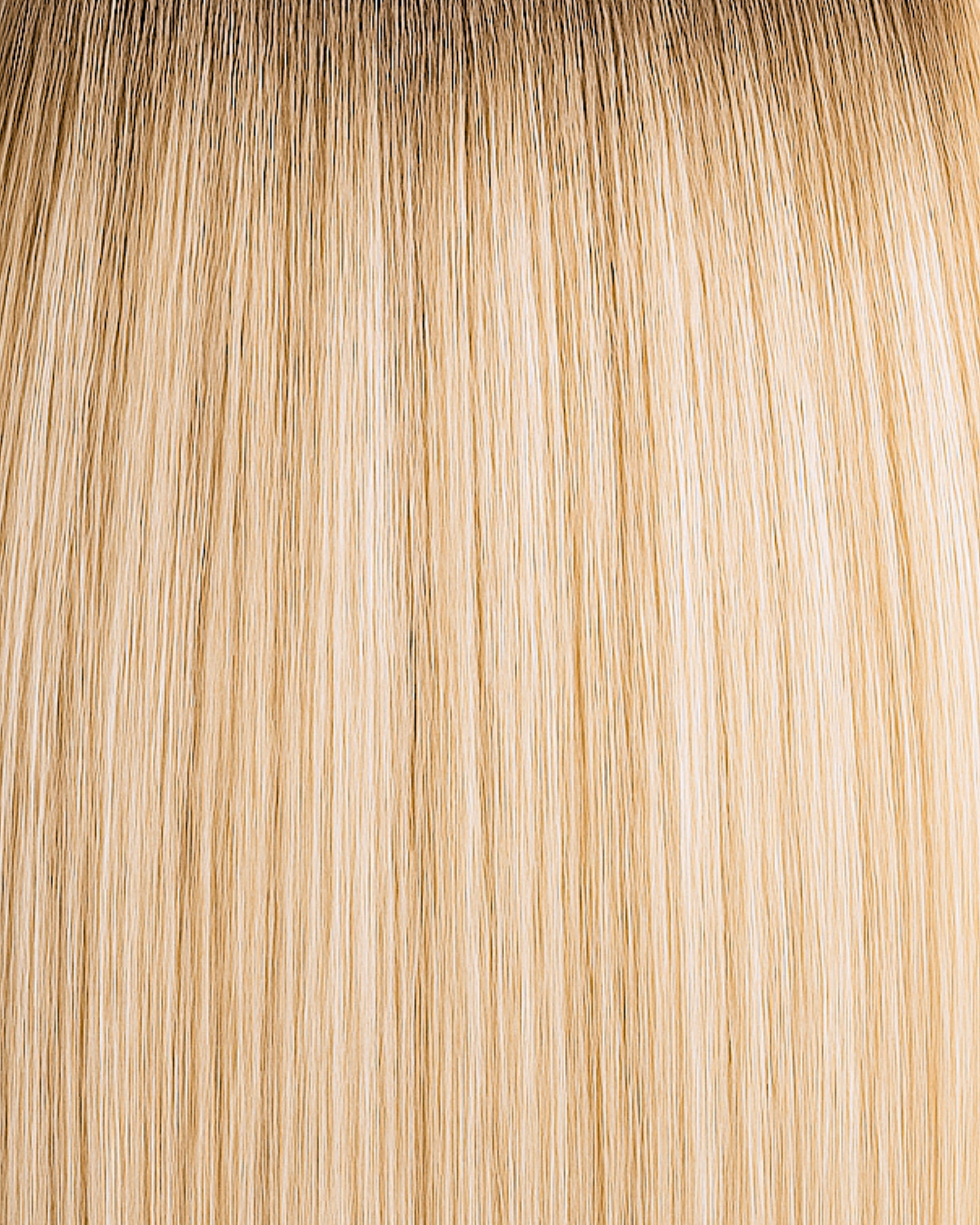 Stitched Hair Spirit Genius Weft™ extensions in rooted vanilla blonde with 10 and 9 warm tones and level 7 root, shown in golden dimensional strands.