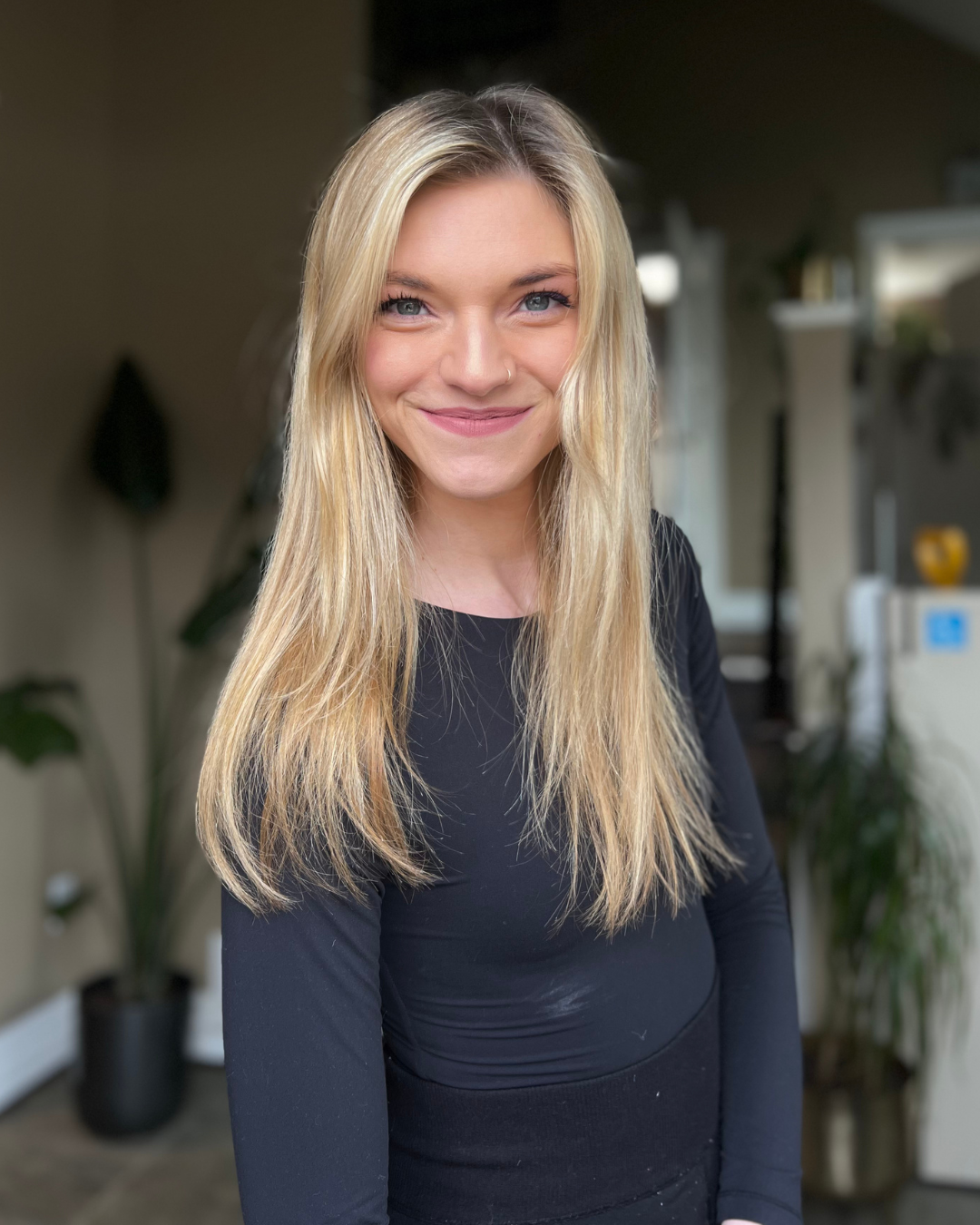 Client with natural, straight blonde hair before Stitched Seam Weft™ extensions by Stitched Hair