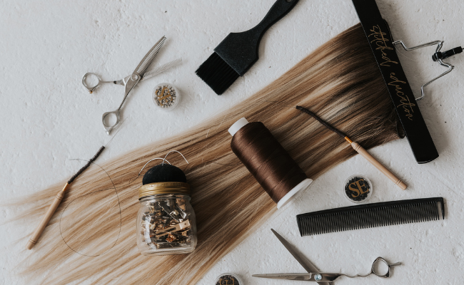 Professional hair extension swatch ring showing all Stitched Hair shades