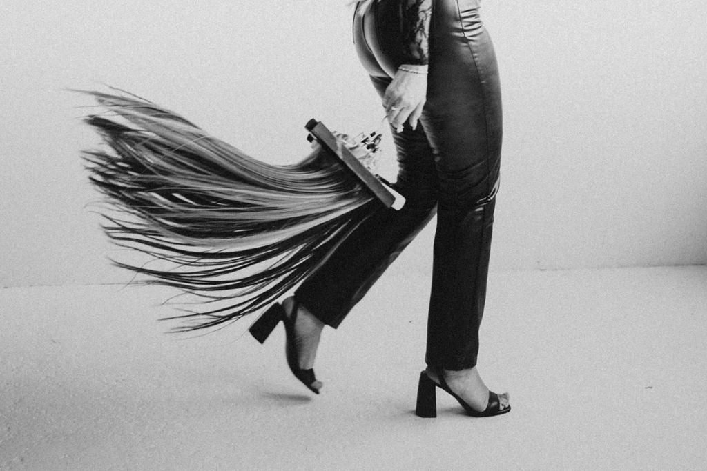 Jessie with long, wavy hair created using Stitched Seam Wefts™