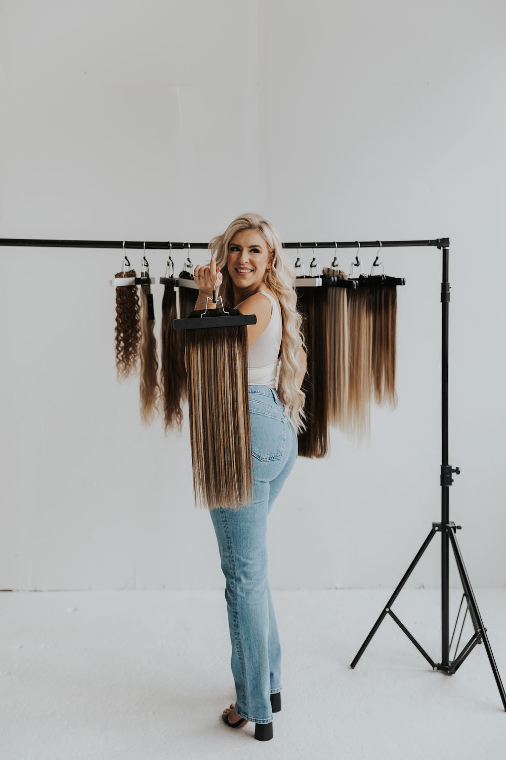 Jessie, founder of Stitched Hair, smiling while wearing Seam Wefts™