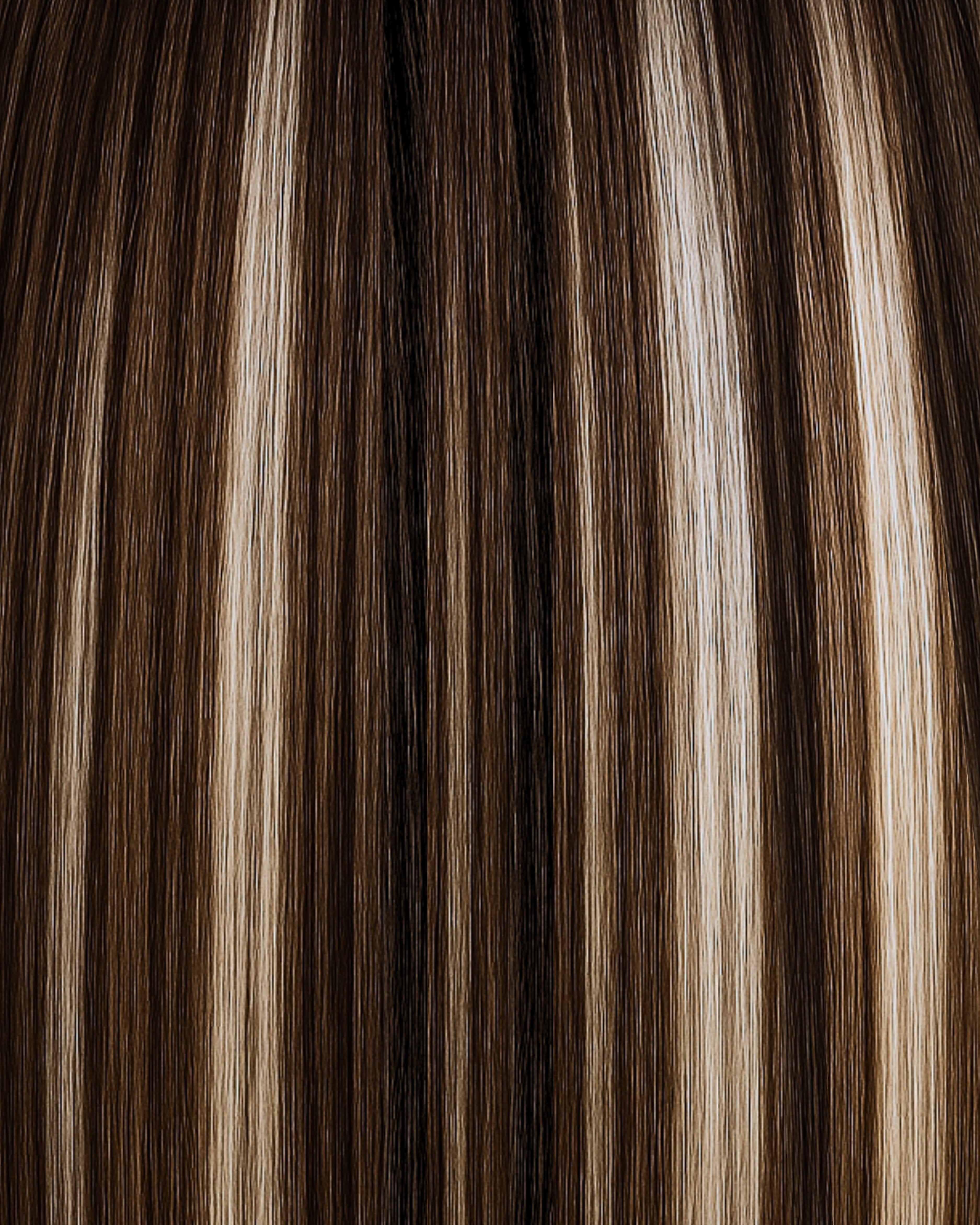 Stitched Hair Elevate Genius Weft™ extensions in rooted chocolate bronde with 10 ash, 8 ash, and level 6 warm root, shown in sleek dimensional strands.
