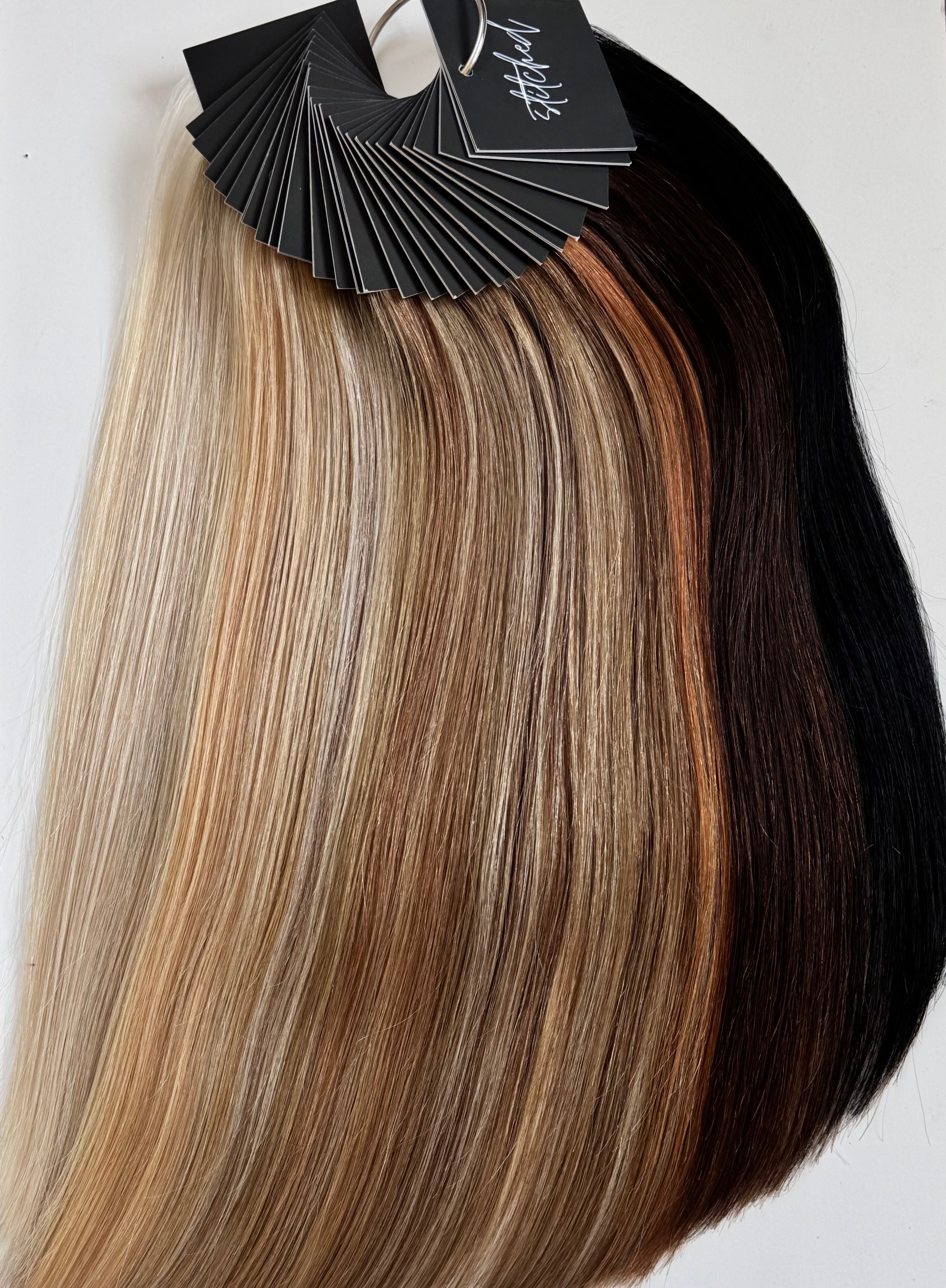Stitched Hair Professional Swatch Ring displaying a full range of Seam Weft™ extension shades on a labeled ring for stylist consultations and color matching.