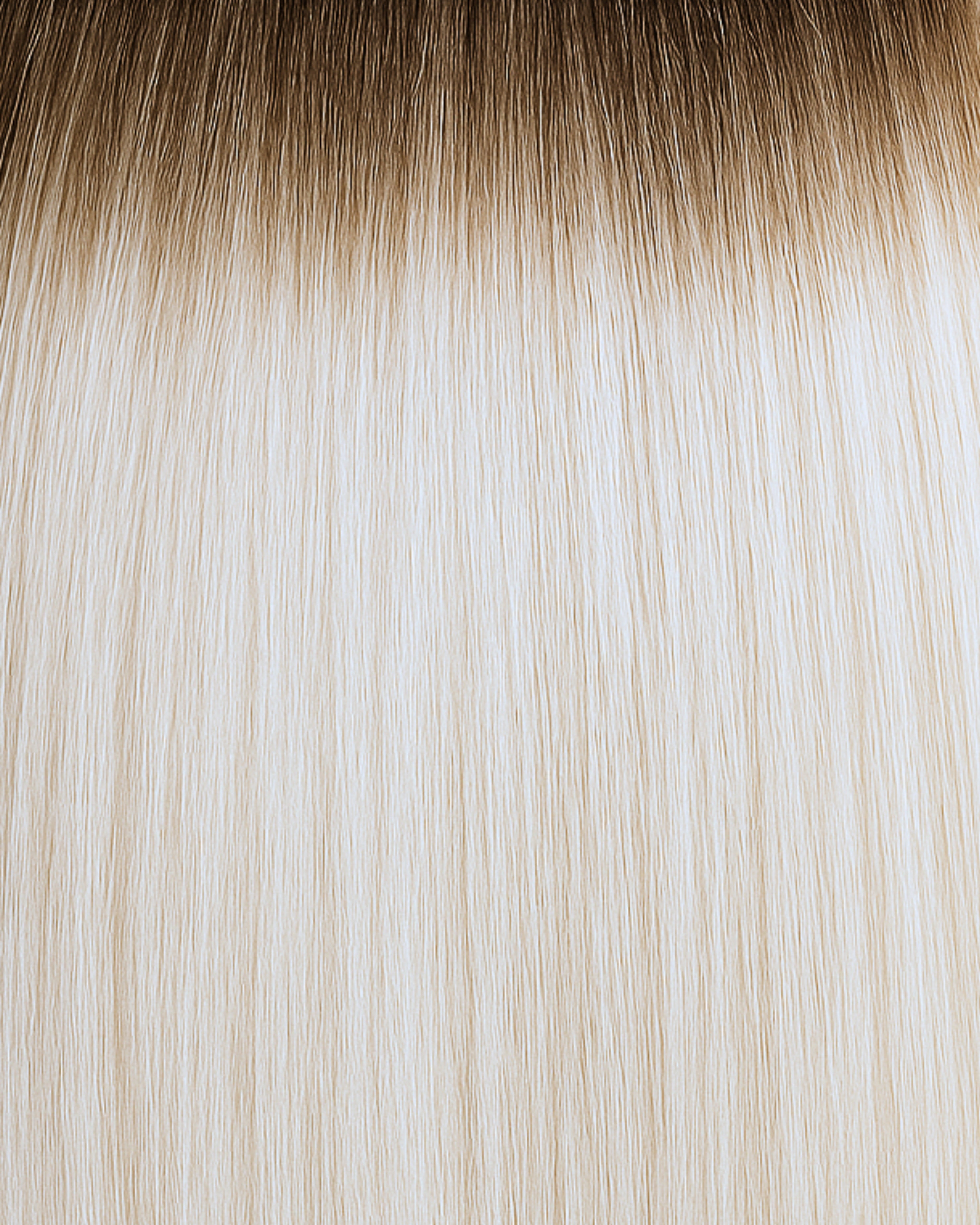 Stitched Hair Iconic Genius Weft™ extensions in rooted platinum blonde with 10 ash tone and level 7 root, shown in sleek, icy strands.