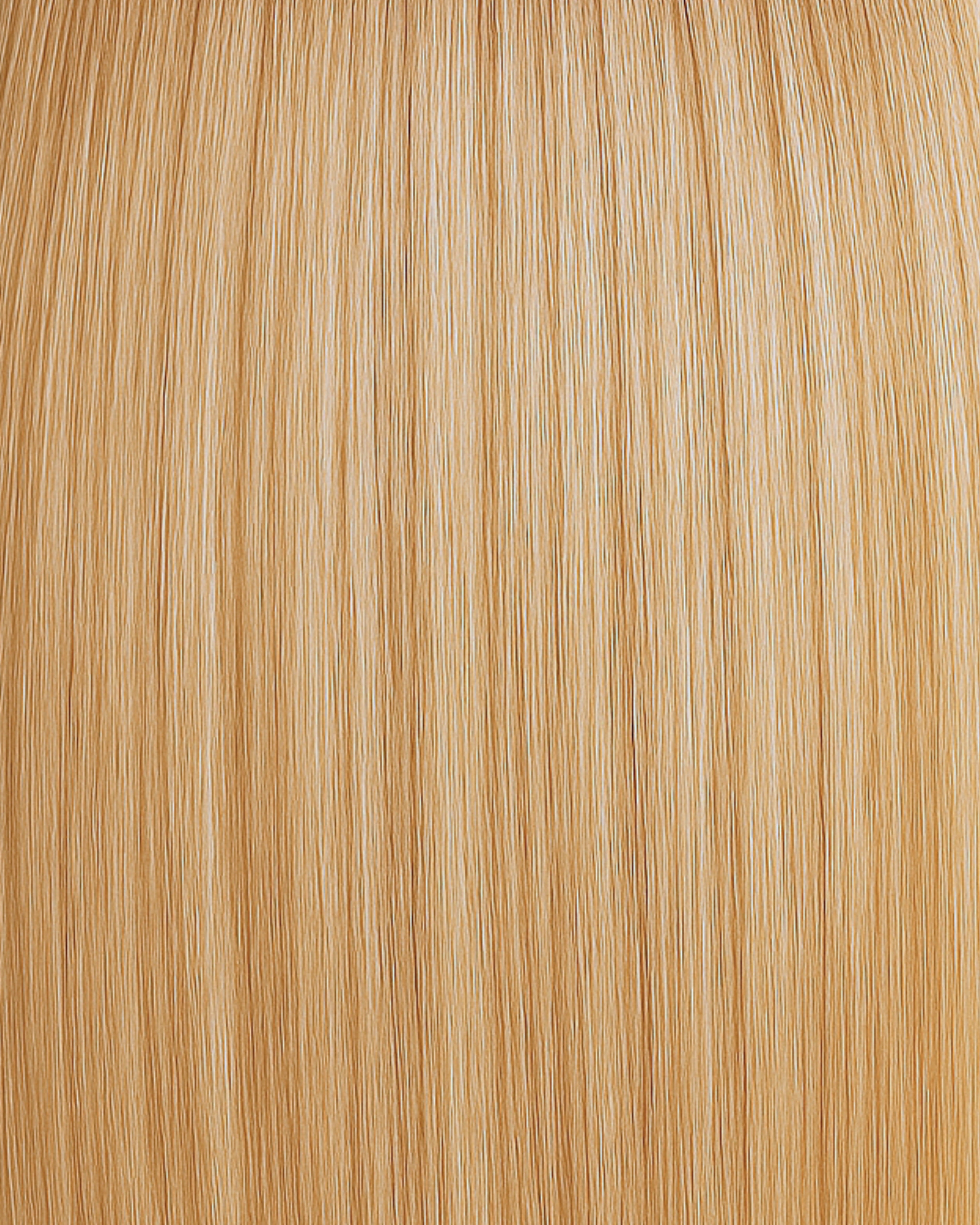 Stitched Hair Shine Genius Weft™ extensions in golden blonde with level 9 warm tone, shown in soft, radiant strands.