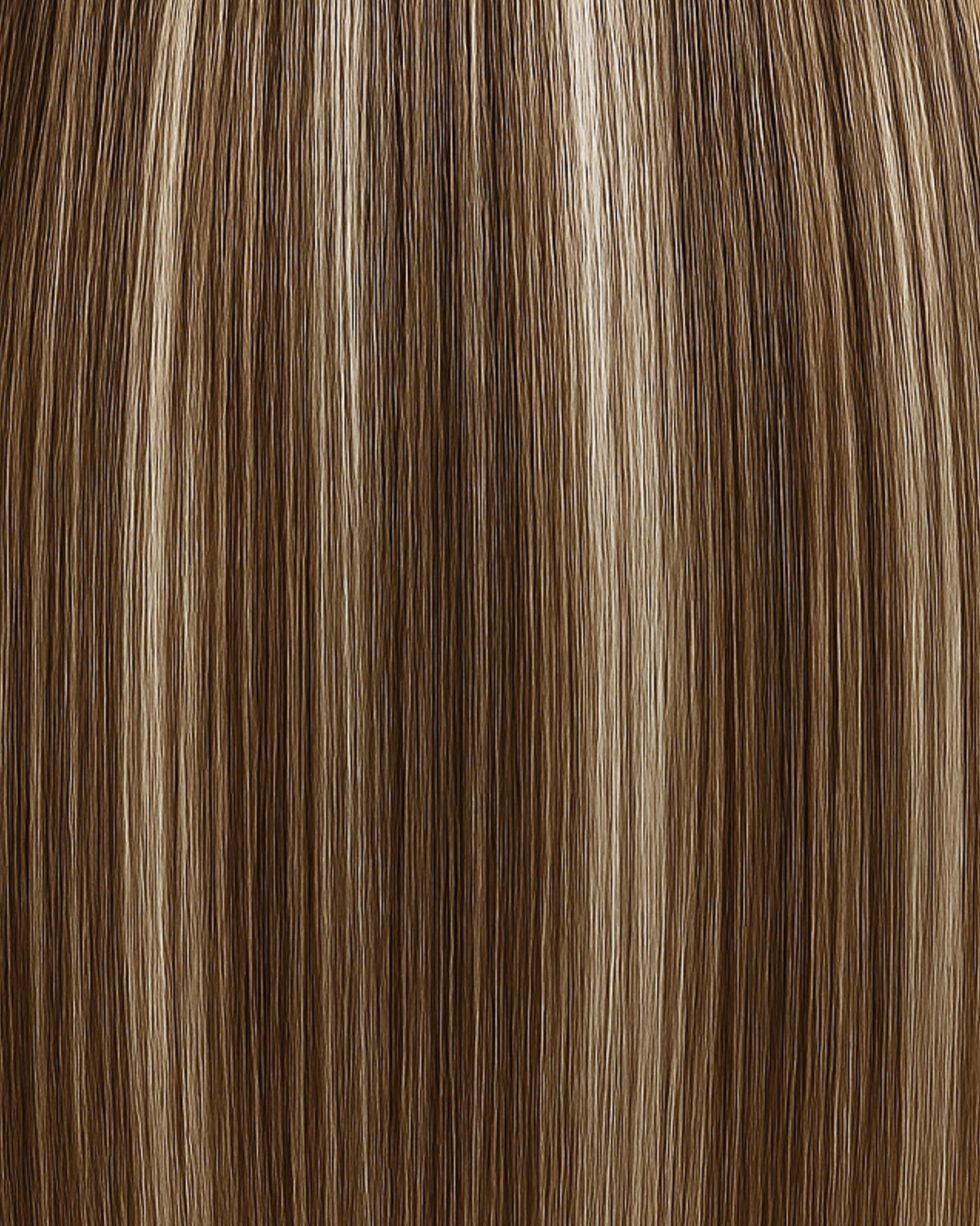 Stitched Hair Mystic Genius Weft™ extensions in rooted dimensional bronde with warm 9 and 6 blend and level 6 root, shown in sleek highlighted strands.